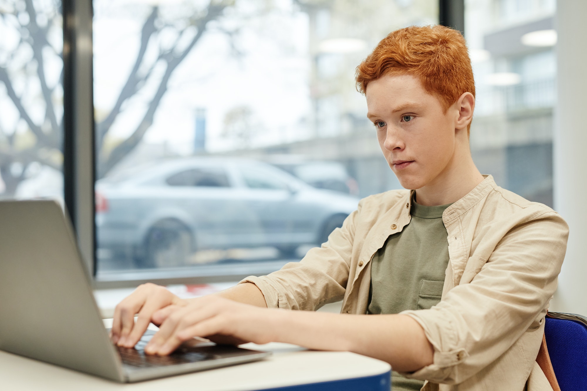 Boy Using Laptop in School