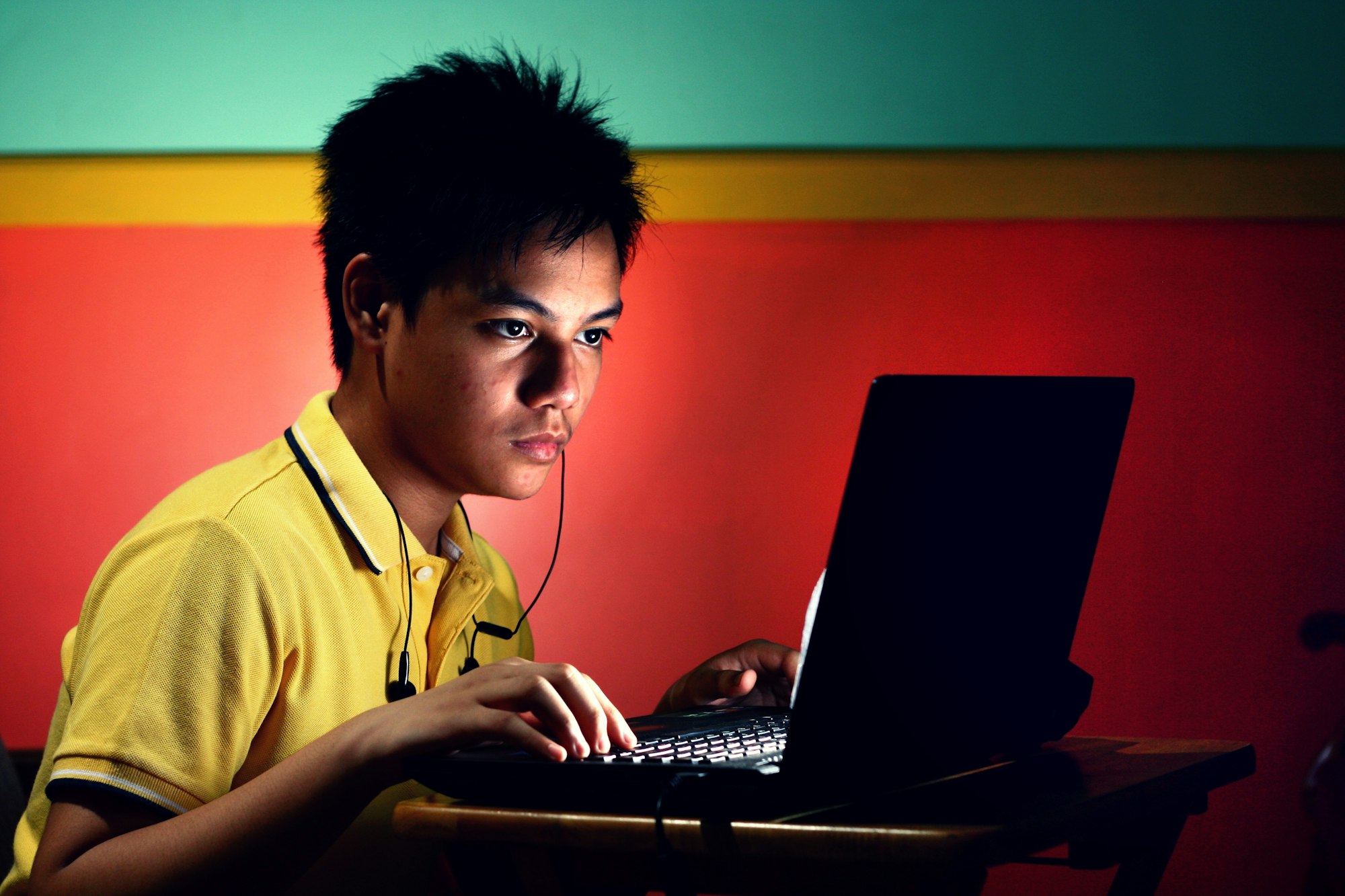 young asian teen with a laptop computer