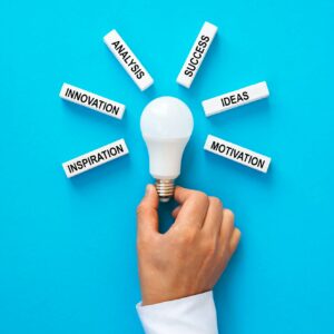 Businessman holding light bulb with wooden blocks with copy space.