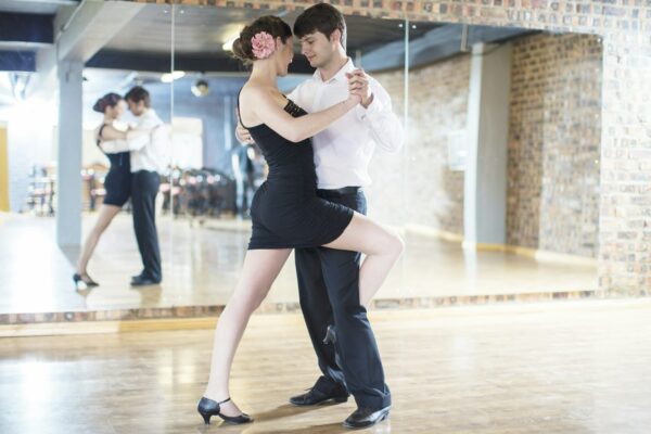 Couple dancing salsa in studio