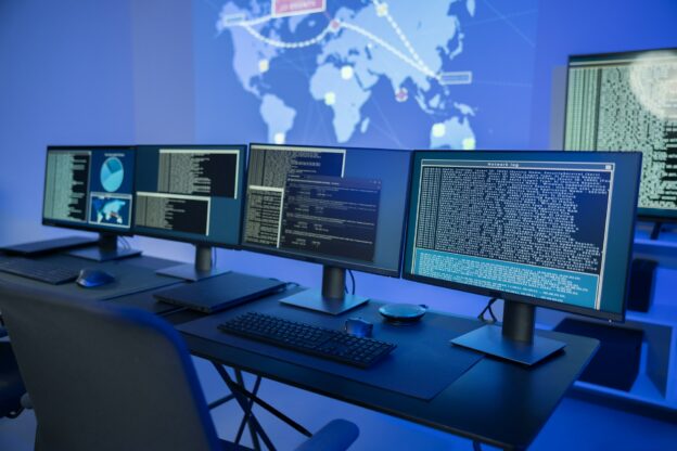 Cyber security command center with multiple monitors displaying data analysis and network