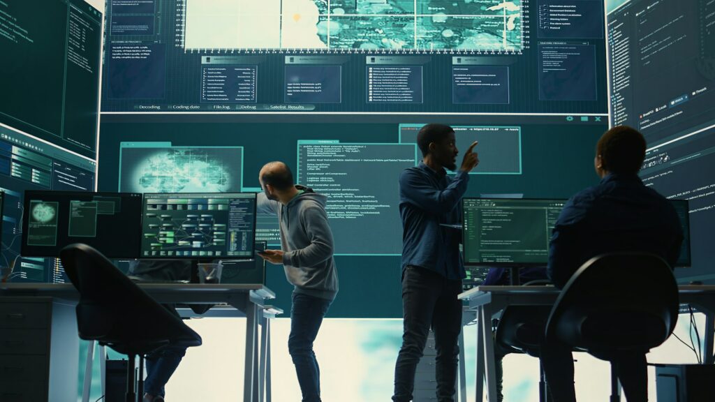 Governmental hackers analyzing cyber threats on big screens