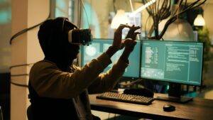 Male cyber criminal hacking network system with vr headset