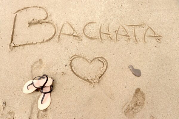 Writing "Bachata" on the sand in a beach