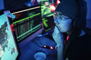 Woman, computer and hacker with music headphones and programming for cybersecurity. Thinking, radio